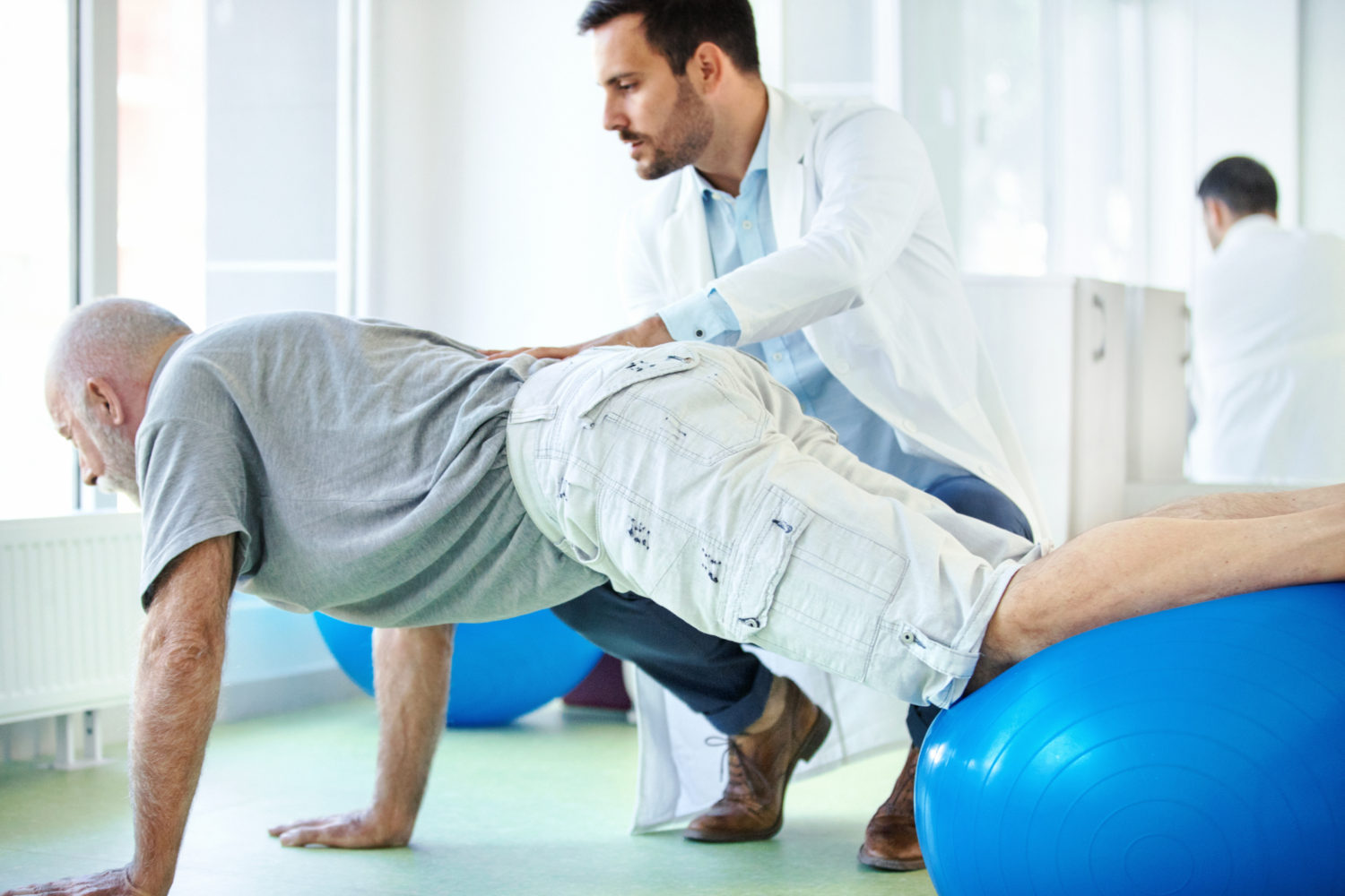 How do we treat low back strains and sprains with manual therapy?